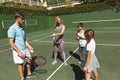 Happy caucasian couple with daughter and son outdoors, playing tennis on tennis court Royalty Free Stock Photo