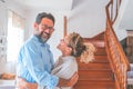Happy caucasian couple embracing each other in the living room. Loving husband and wife hugging at home. Affectionate man and Royalty Free Stock Photo