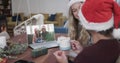 Happy caucasian couple and mother and daughte having christmas laptop video call, slow motion