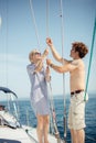 Young caucasian attractive couple navigating a yacht in caribbean sea Royalty Free Stock Photo