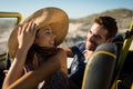 Happy caucasian couple sitting in beach buggy by the sea smiling Royalty Free Stock Photo