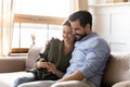 Happy Caucasian couple use cellphone at home together Royalty Free Stock Photo