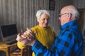 Happy caucasian elderly woman dancing with her husband together in the living room of their own house Royalty Free Stock Photo