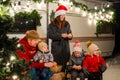 Happy Caucasian family celebrating Christmas outdoors. Parents and three sons travel in a camper. Royalty Free Stock Photo