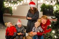 Happy Caucasian family celebrating Christmas outdoors. Parents and three sons travel in a camper. Royalty Free Stock Photo