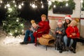 Happy Caucasian family celebrating Christmas outdoors. Parents and three sons travel in a camper. Royalty Free Stock Photo