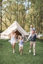 Happy Caucasian family, father mother and two little daughters, having fun outdoors in park or camping, enjoying time Royalty Free Stock Photo