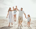 Happy caucasian family of four having fun while enjoying a summer vacation together at the beach shore. Loving parents Royalty Free Stock Photo