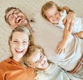 A happy Caucasian family of four lying in the living room at home. Loving smiling family being affectionate on the Royalty Free Stock Photo