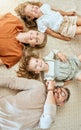 A happy Caucasian family of four lying in the living room at home. Loving smiling family being affectionate on the Royalty Free Stock Photo