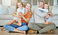 A happy Caucasian family of four relaxing in the living room at home. Loving smiling family being affectionate on the Royalty Free Stock Photo