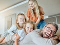 A happy Caucasian family of four relaxing on the sofa at home. Loving smiling family being affectionate on the sofa Royalty Free Stock Photo