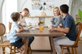 Happy Caucasian family having breakfast together at table . Beautiful kind family talking while eating together in the modern Royalty Free Stock Photo