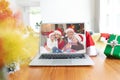 Happy caucasian family having christmas laptop video call on table Royalty Free Stock Photo