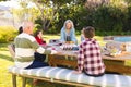Happy caucasian family spending time together and having meal in the garden Royalty Free Stock Photo