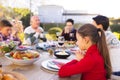 Happy caucasian family spending time together and praying before meal in the garden Royalty Free Stock Photo