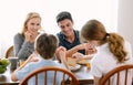 Happy caucasian family with teenage daughter and son smiling and talking while having breakfast in modern kitchen. Family,healthy, Royalty Free Stock Photo