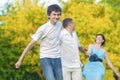 Happy Caucasian Family of Three Having Fun Together and Running in Summer Forest With Joined Hands Royalty Free Stock Photo