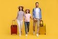 Happy Caucasian Family Of Three Holding Hands And Walking With Suitcases Royalty Free Stock Photo