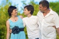 Happy Caucasian Family of Three Spending Time Together. Walking Embraced in Park. Royalty Free Stock Photo