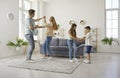 Happy Caucasian family with two children, small son and daughter, dancing together at home. Royalty Free Stock Photo