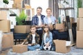 Caucasian family with two kids posing among boxes at new house Royalty Free Stock Photo