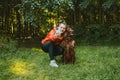 Happy caucasian girl hiker hiker takes a selfie with her cute Irish Setter dog on a walk in a summer forest Royalty Free Stock Photo