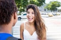 Happy caucasian girl speaking with african american girlfriend