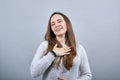 Happy caucasian lady keeping palm on chest, smiling wearing fashion blue sweater Royalty Free Stock Photo