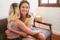 Happy Caucasian Lesbian couple cuddling each other with a smile and warmth on the sofa. Best partner embracing hugging. LGBTQ Royalty Free Stock Photo