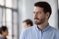 Happy Caucasian male employee look in distance thinking Royalty Free Stock Photo