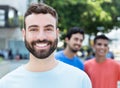 Happy caucasian man with beard with two friends in the city Royalty Free Stock Photo