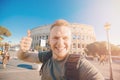 Happy caucasian man tourist with backpack taking selfie photo Colosseum in Rome, Italy. Travel trip concept Royalty Free Stock Photo