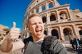 Happy caucasian man tourist with backpack taking selfie photo Colosseum in Rome, Italy. Travel trip concept Royalty Free Stock Photo