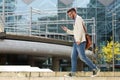 Happy caucasian man walking outdoors and reading text message Royalty Free Stock Photo