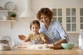 Happy Caucasian mom and small daughter bake together Royalty Free Stock Photo