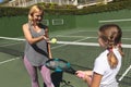 Happy caucasian mother with daughter outdoors, playing tennis on tennis court Royalty Free Stock Photo