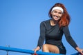 Happy Caucasian Red Haired Sportswoman Posing on Parallel Bars