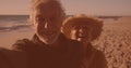 Happy caucasian senior couple talking a selfie together at the beach Royalty Free Stock Photo