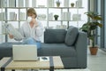 Happy  Caucasian senior woman  is relaxing , reading newspaper in living room Royalty Free Stock Photo