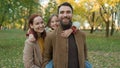 Happy Caucasian smiling family portrait in city outdoors together smile laughing parents with little daughter piggyback Royalty Free Stock Photo