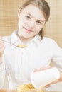 Happy Caucasian Teenager Girl Eating Breakfast on Kitchen Royalty Free Stock Photo