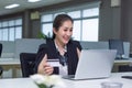 Happy Caucasian woman buying things online, using  laptop and credit card, enjoying shopping in internet Royalty Free Stock Photo