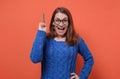 Happy caucasian woman in eyeglasses having idea pointing with pencil up. Royalty Free Stock Photo