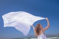 Happy Caucasian woman holding scarf at beach Royalty Free Stock Photo