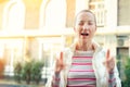 Happy caucasian young adult hipster girl portrait winking and showing thums up sign outdoors at warm sunset evening at autumn. Royalty Free Stock Photo