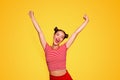 Happy celebrating winning success woman isolated on red baskground with arms raised up above her head. Success and life Royalty Free Stock Photo