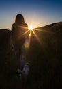 Happy celebrating winning success woman at sunset or sunrise standing elated with arms raised up above her head in Royalty Free Stock Photo