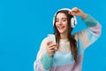 Happy charismatic and carefree smiling european woman enjoying awesome music quality sound in new headphones received as