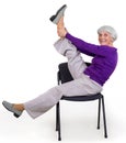 Happy charming beautiful elderly woman doing exercises at home on a chair. Workout gymnastics for health. On a white background